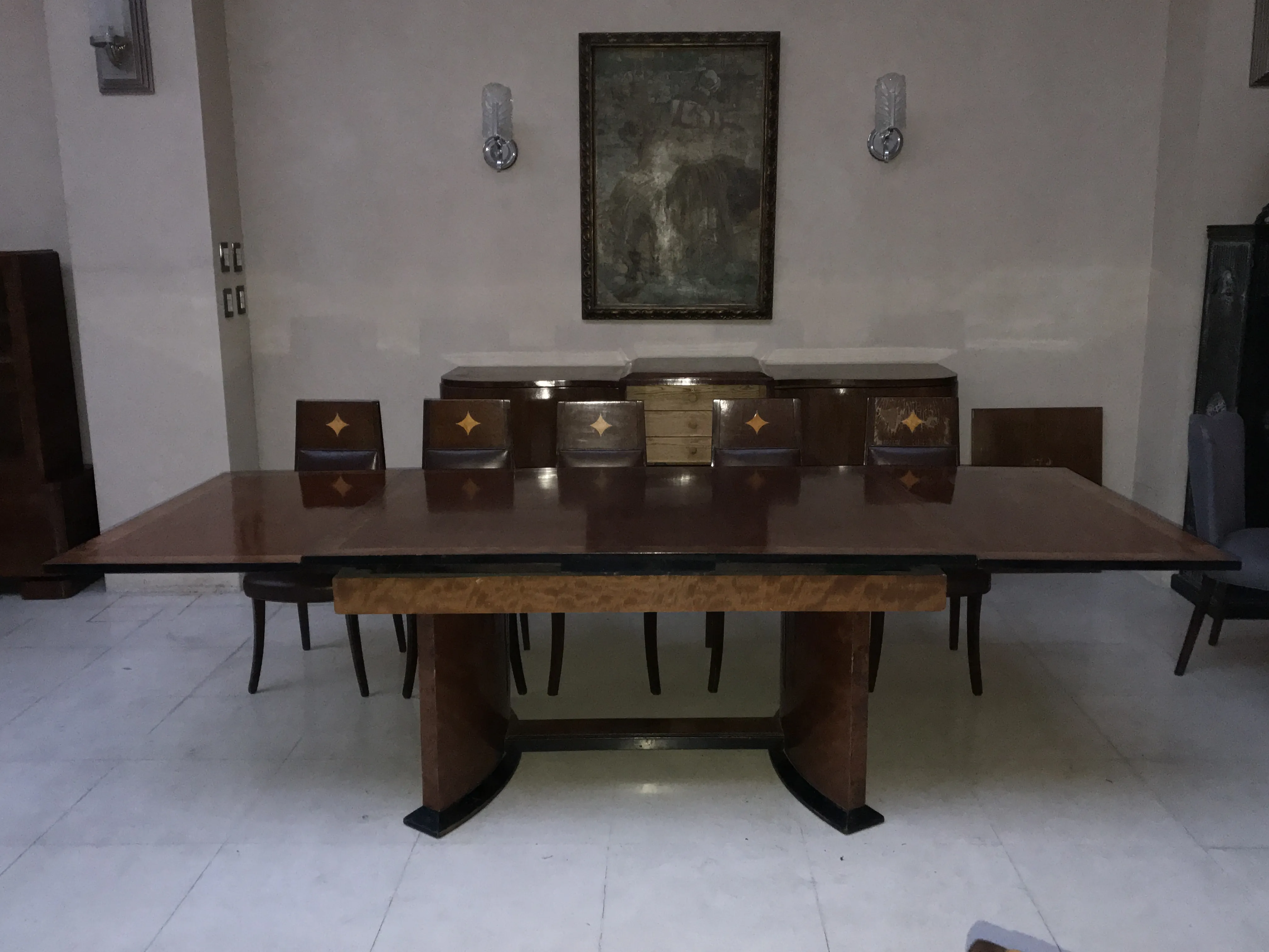 Antique dining table for 12 people in an elegant setting.