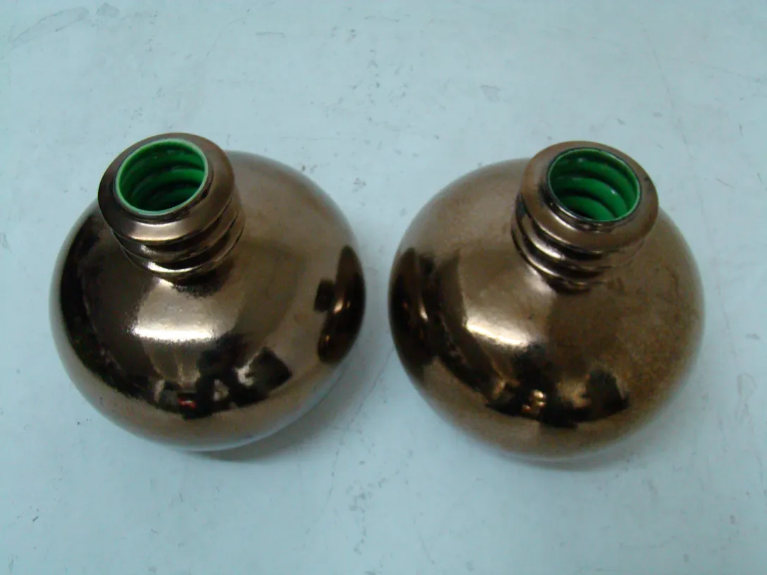 two antique ceramic bottles with green tops
