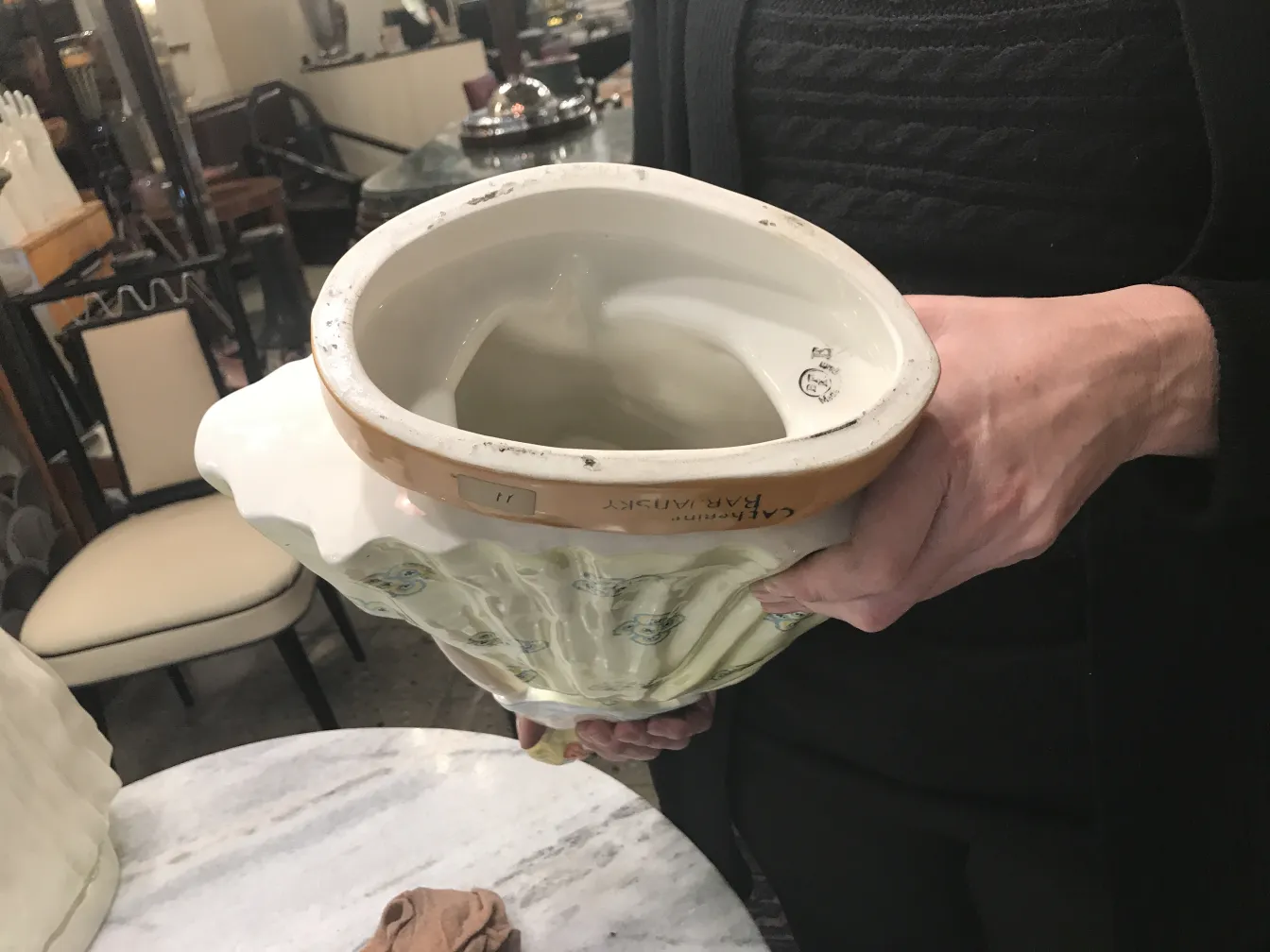 Antique ceramic with decorative artisan patterns and soft colors.