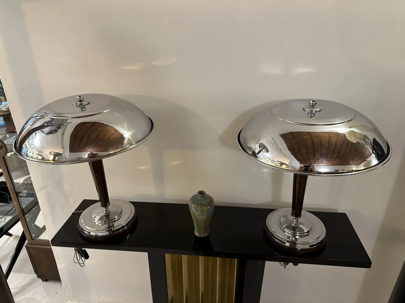 antique ceramic vase on a shelf with lamps