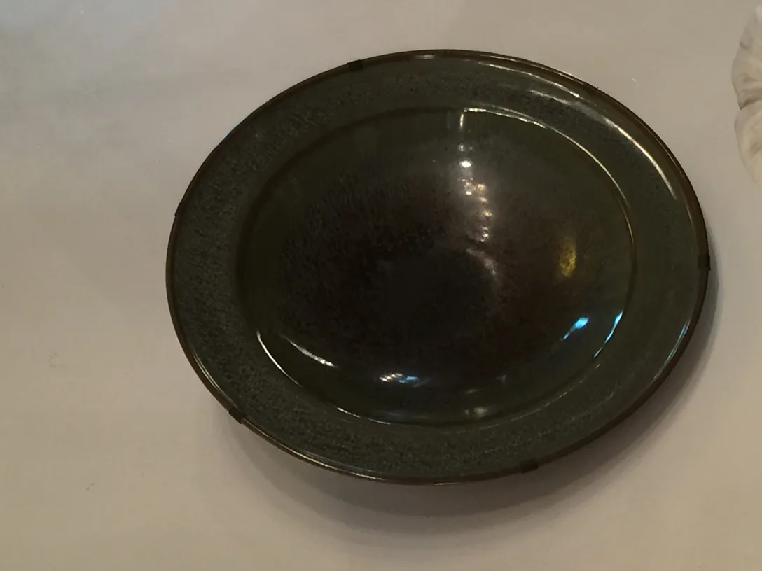 Antique black ceramic plate with smooth edge