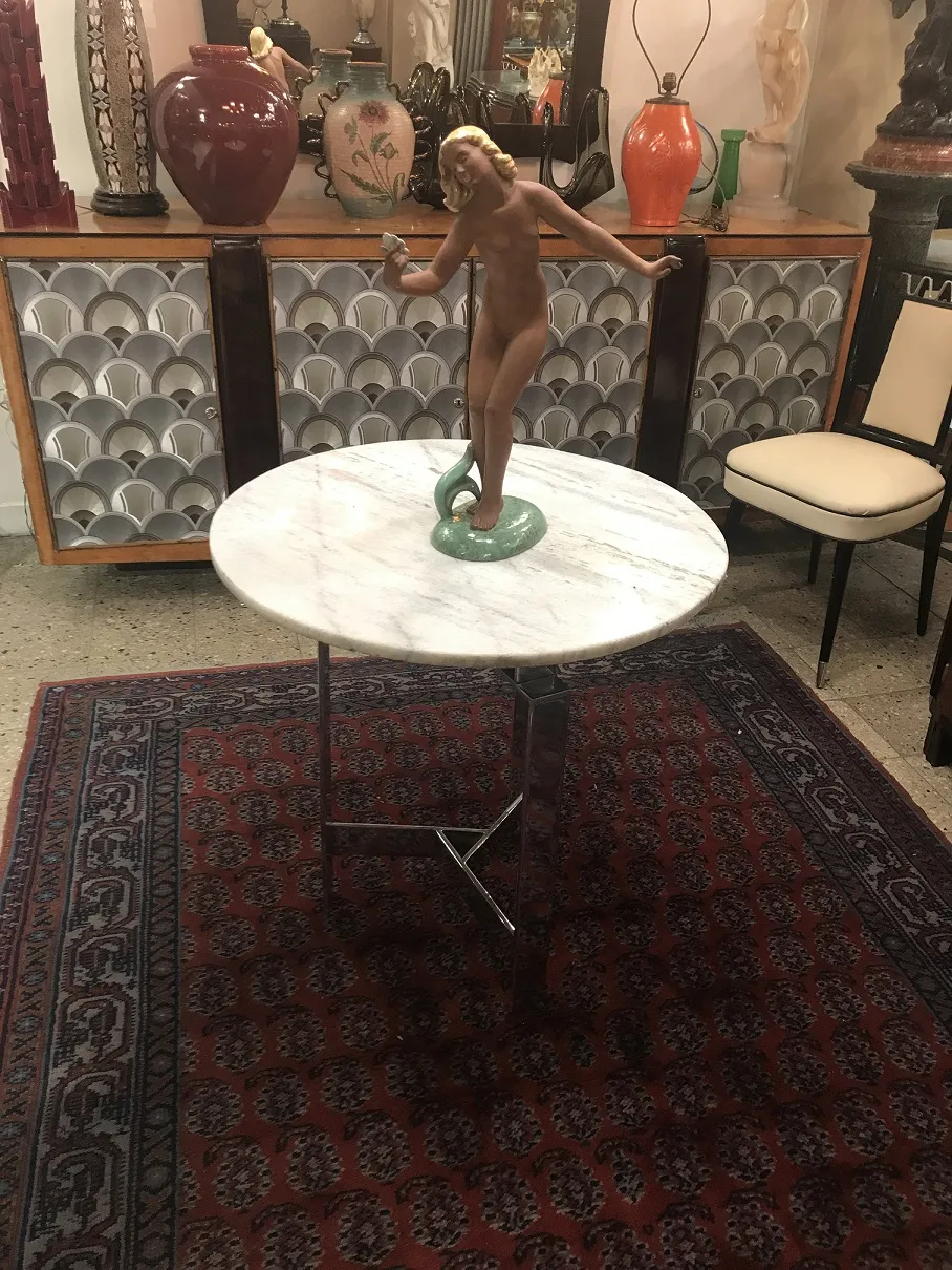 Runder weißer Tisch mit einer keramischen Figur einer nackten Frau