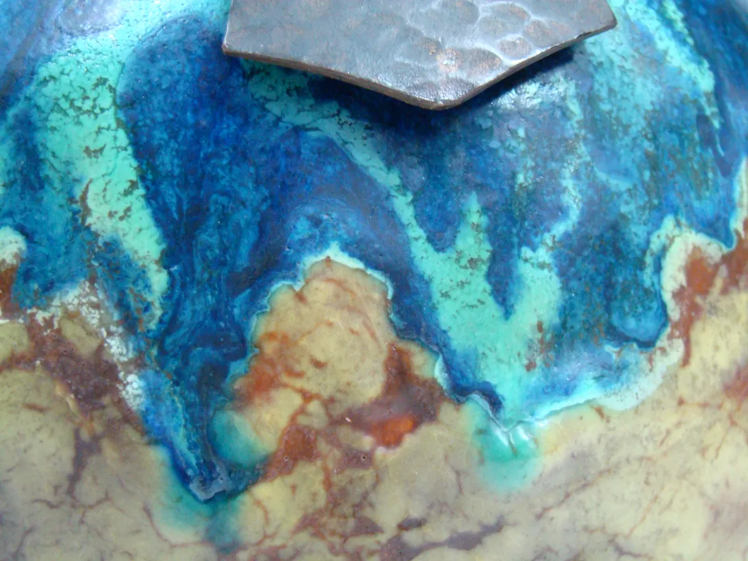 Cerâmica antiga com cores vibrante, azul e marrom.