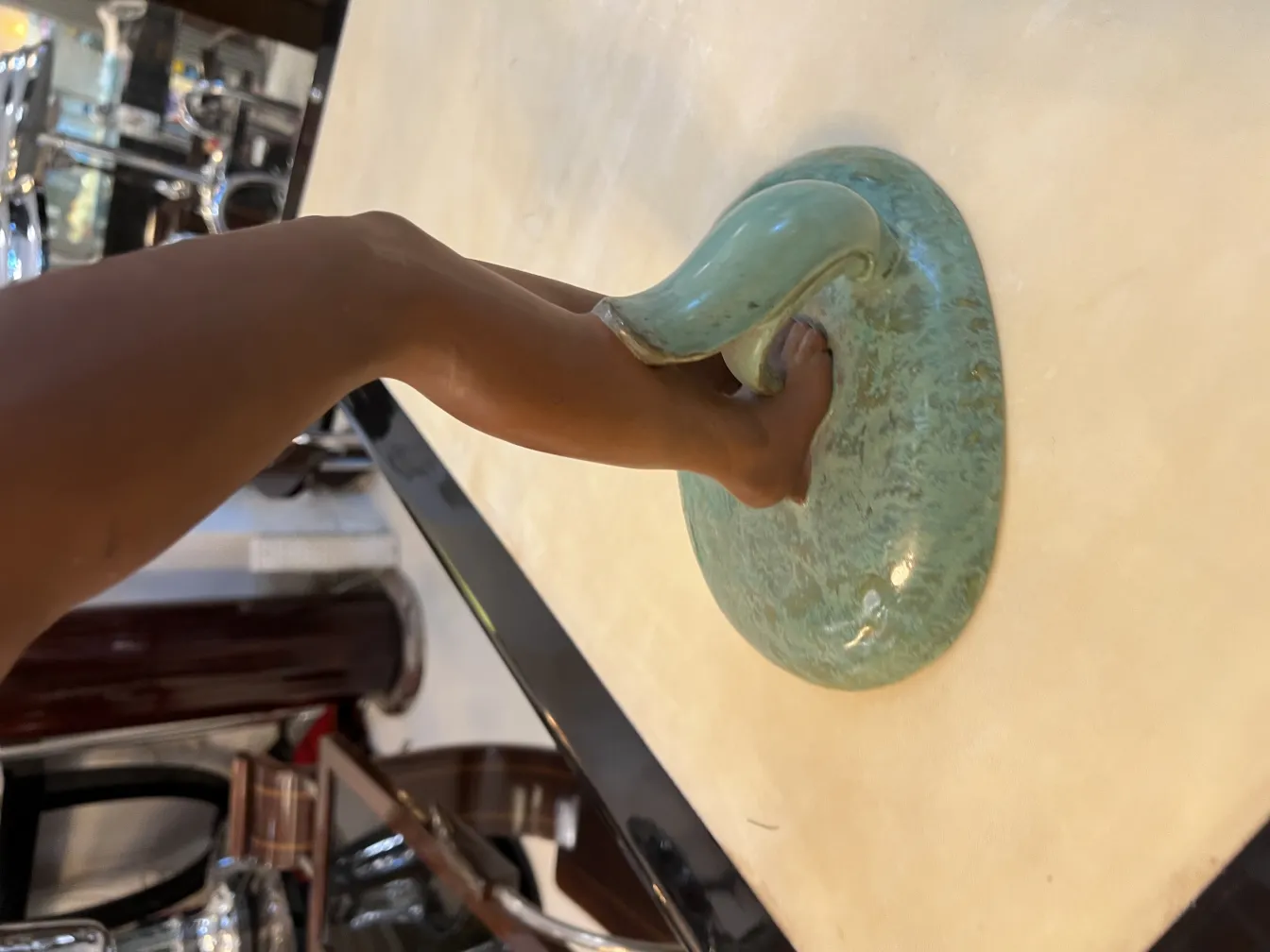 Details of an antique ceramic piece with curved arm and round base