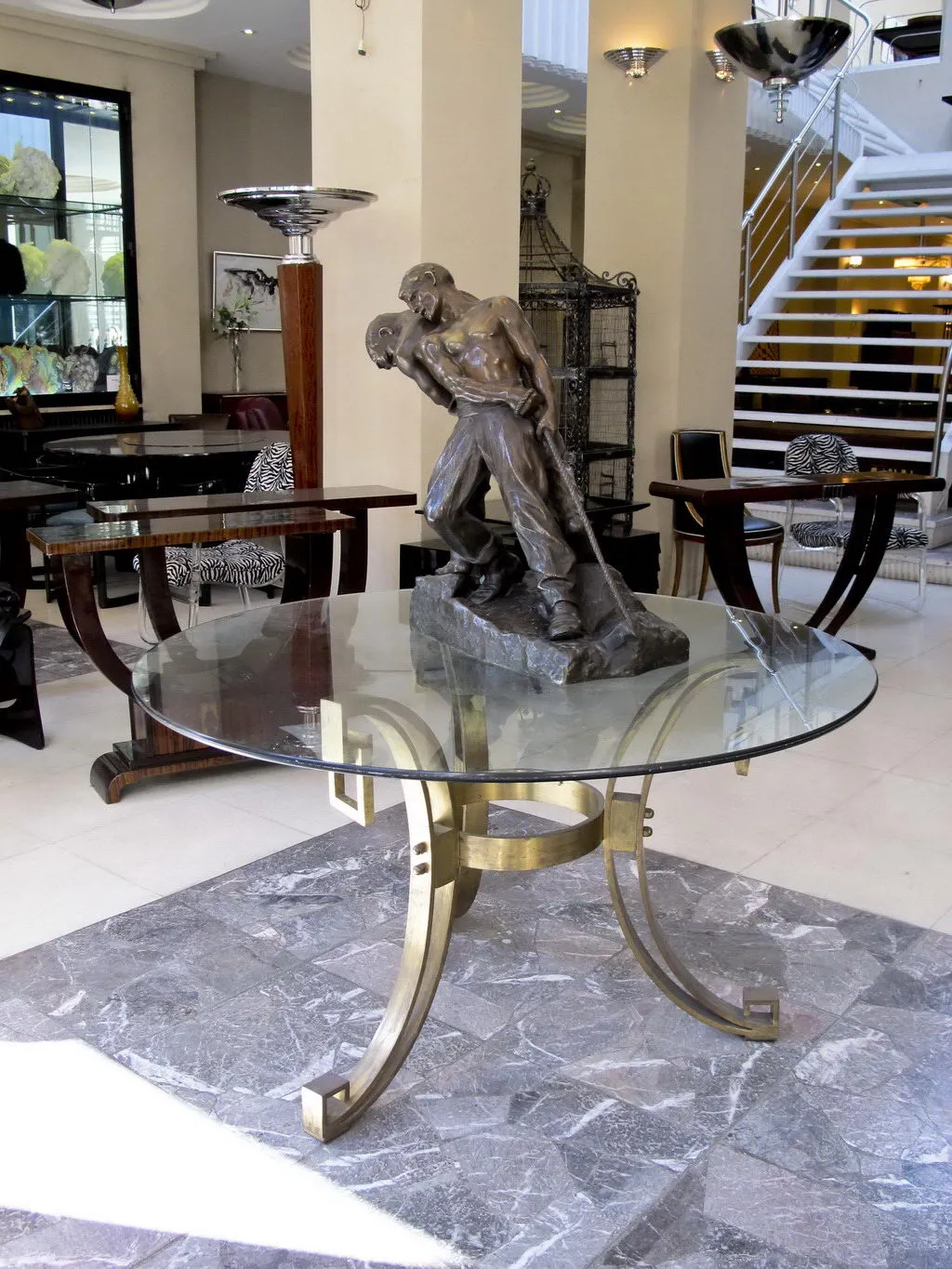 antique dining table for four people with decorative base.