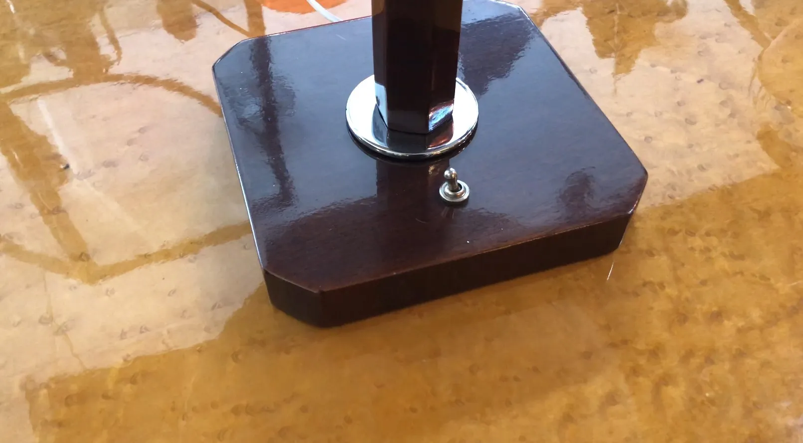 lampara de mesa antigua con base hexagonal sobre una superficie brillante y clara