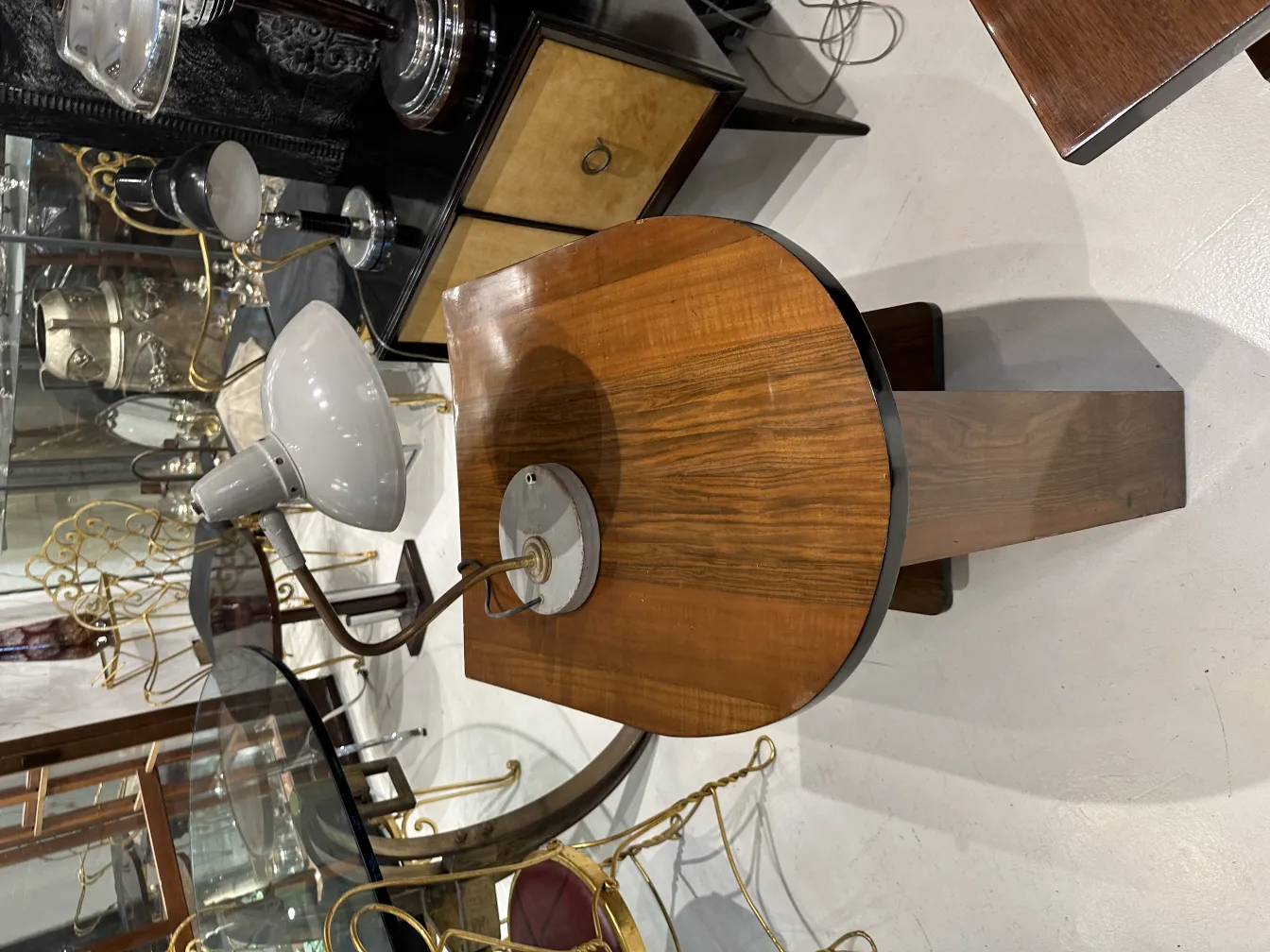table lamp with wooden base and gray shade, in an antique environment