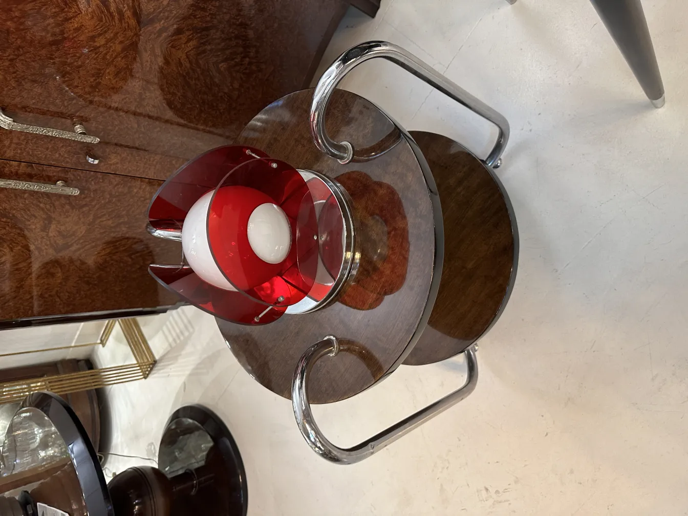 Antique table lamp with red design details on a table