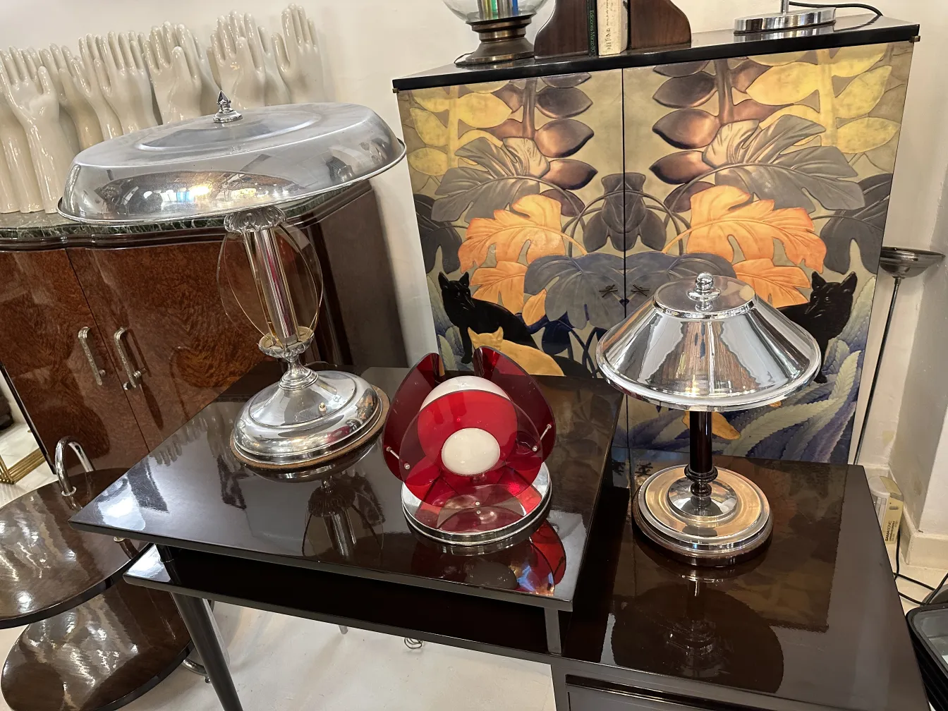 Antique table lamp with a metallic base and shiny shade, enhancing a cozy atmosphere.