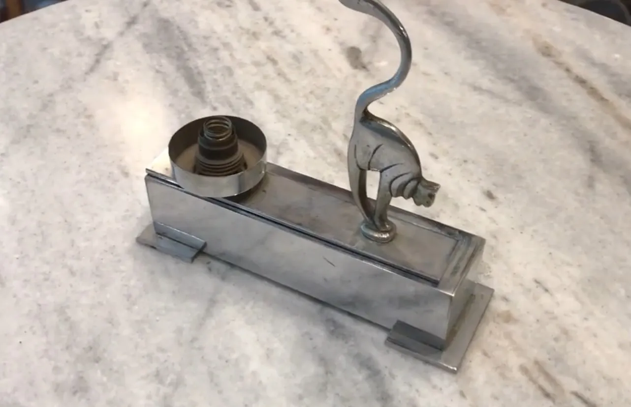 antique table lamp with cat design on marble table