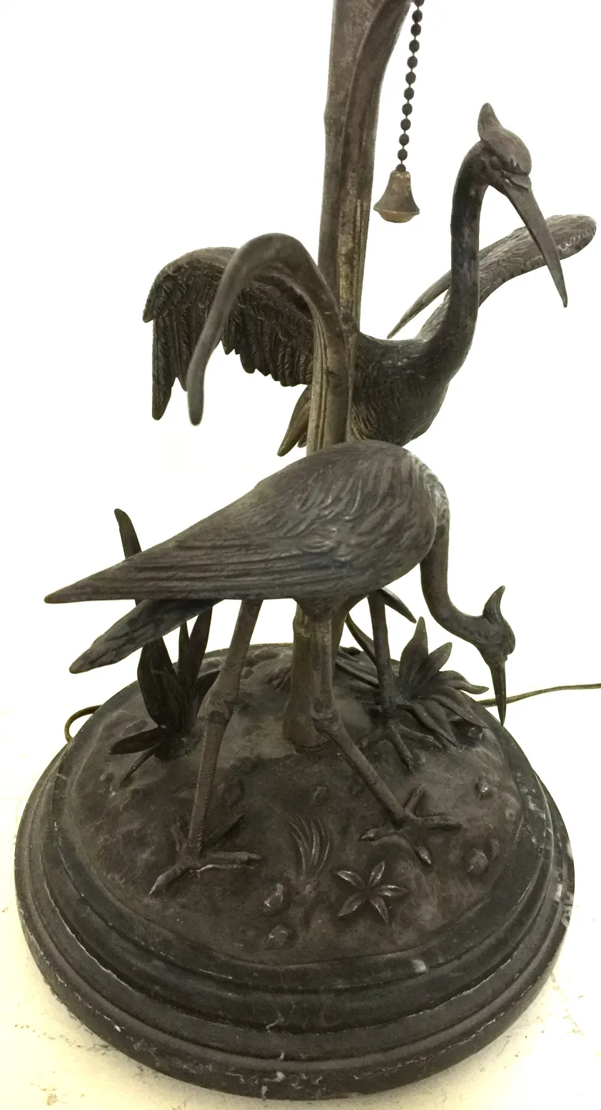 Antique table lamp featuring birds in the design. Decorative base.