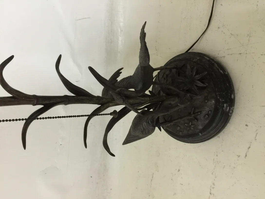 Antique table lamp featuring birds on the base.