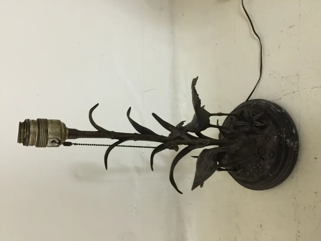 Lampe de bureau antique avec un design organique, présentant des feuilles et des fleurs à la base.