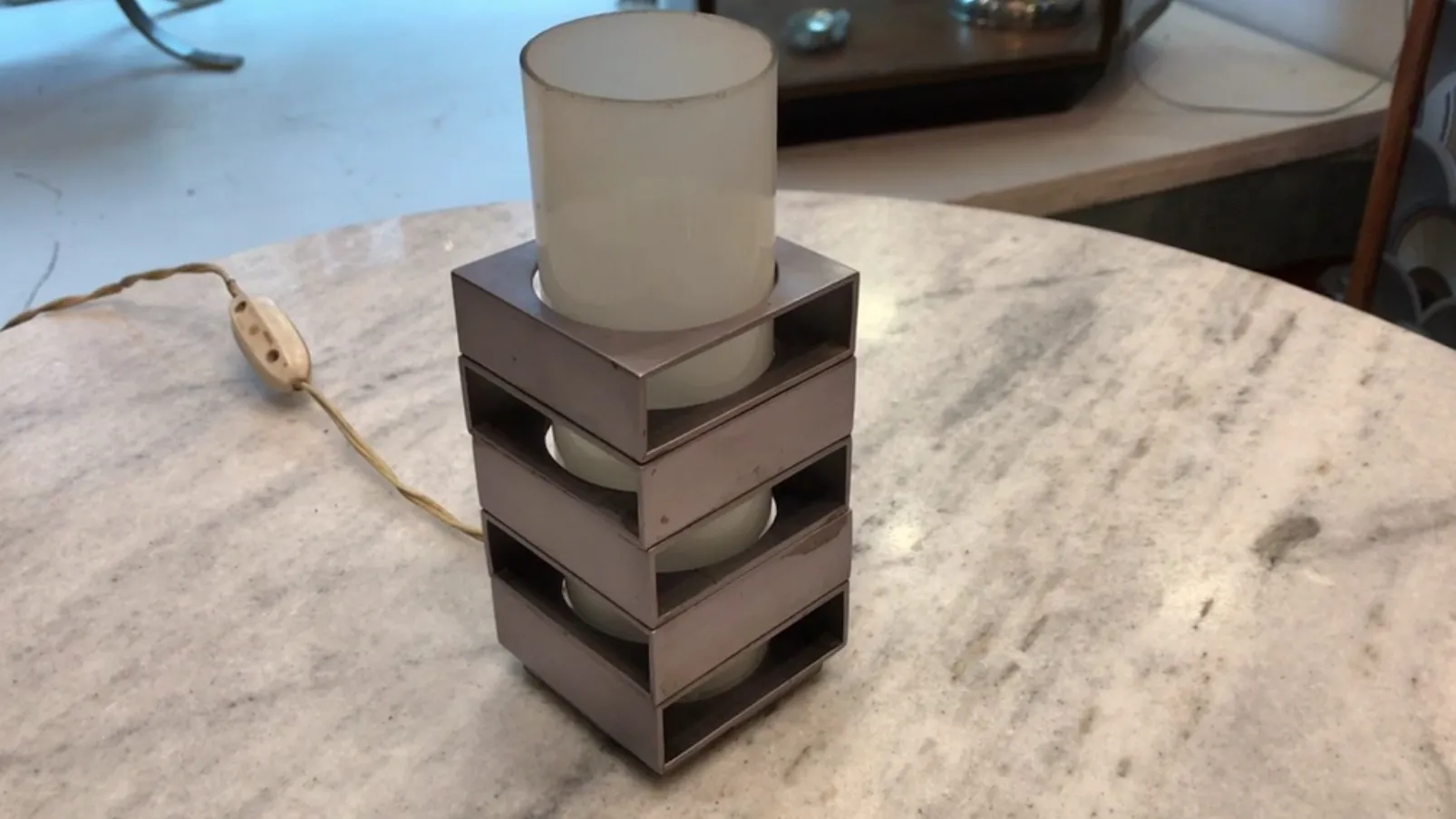 Antique table lamp with modern design on a light surface.