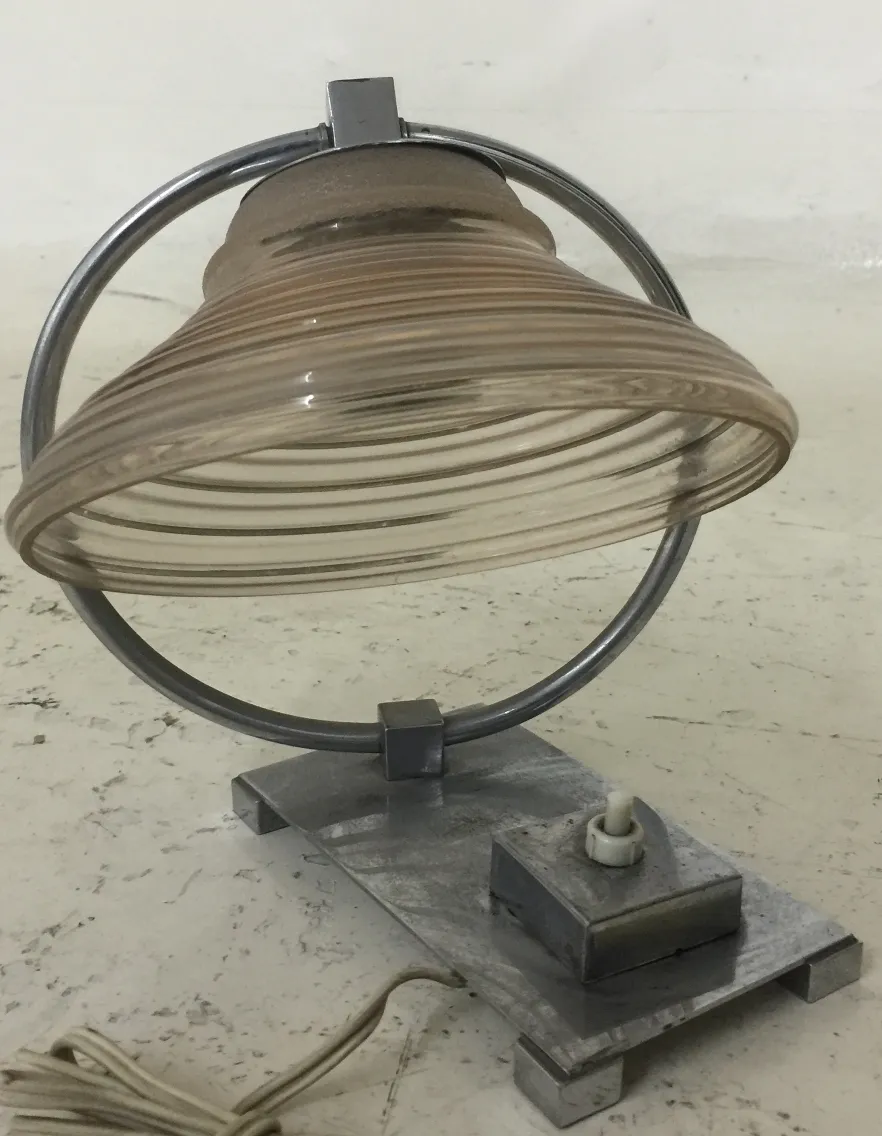 Antique table lamp with unique design and metal base, perfect for classic settings.