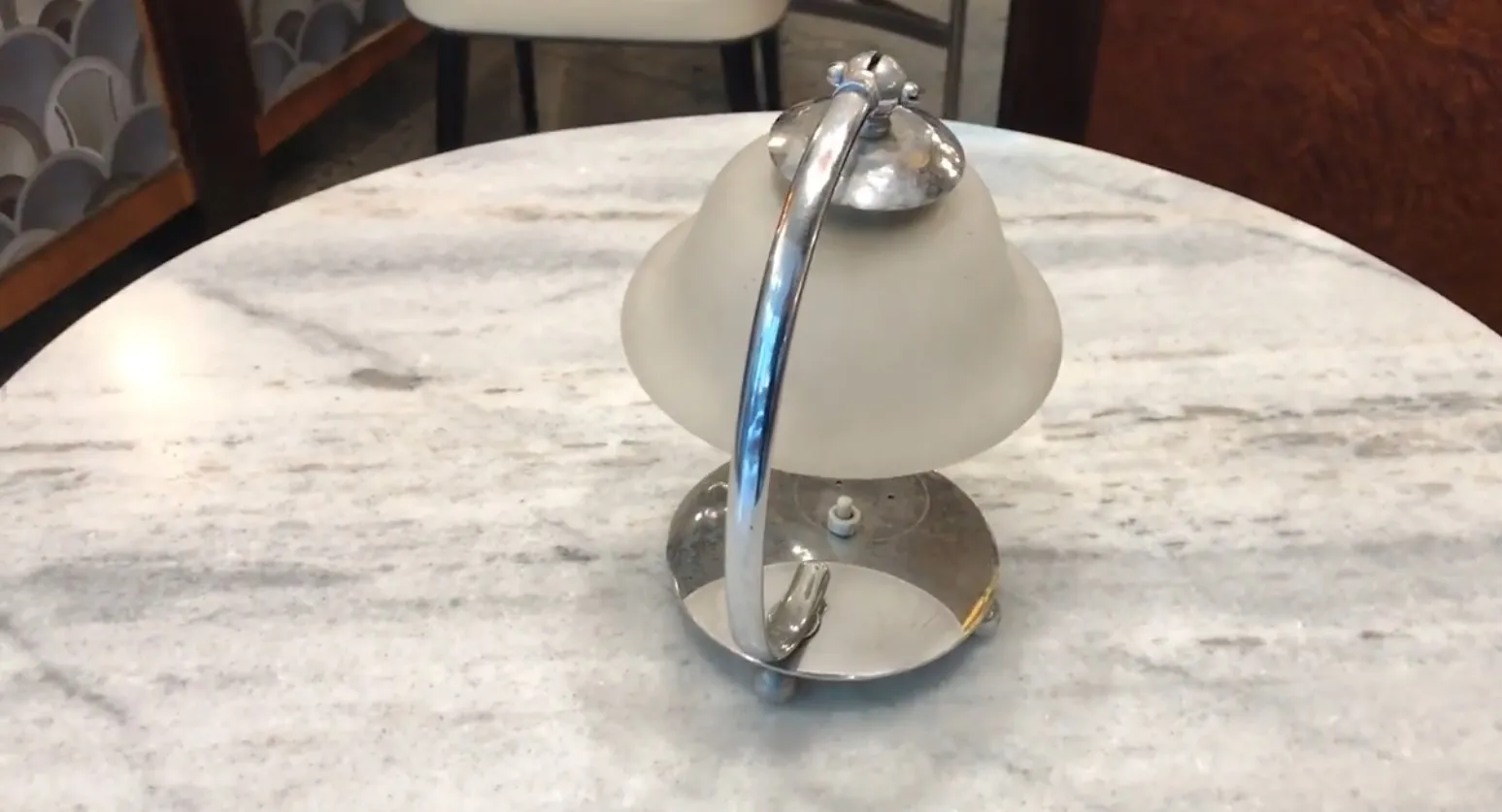 Antique table lamp with shiny base on a table