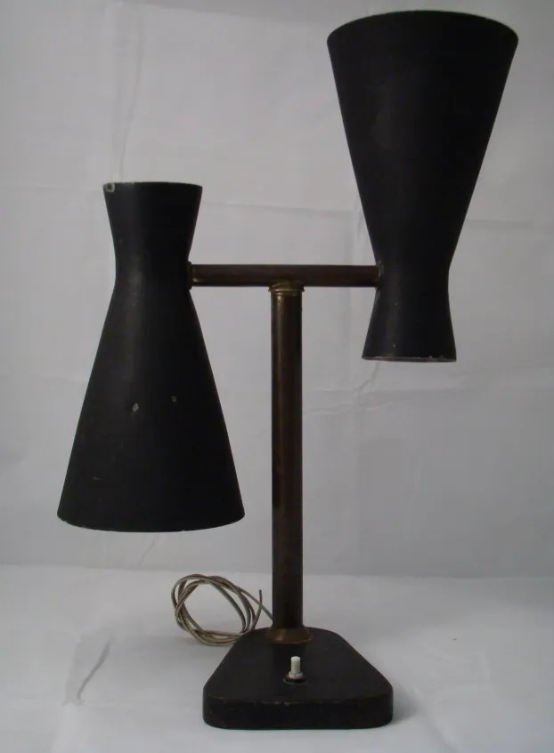 Vintage table lamp with minimalist design, dark colors, soft ambient light.