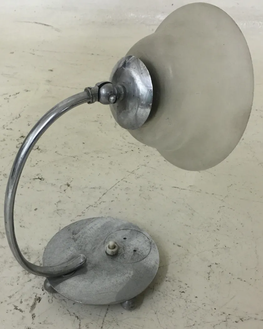 antique table lamp with curved shade and round base in neutral setting