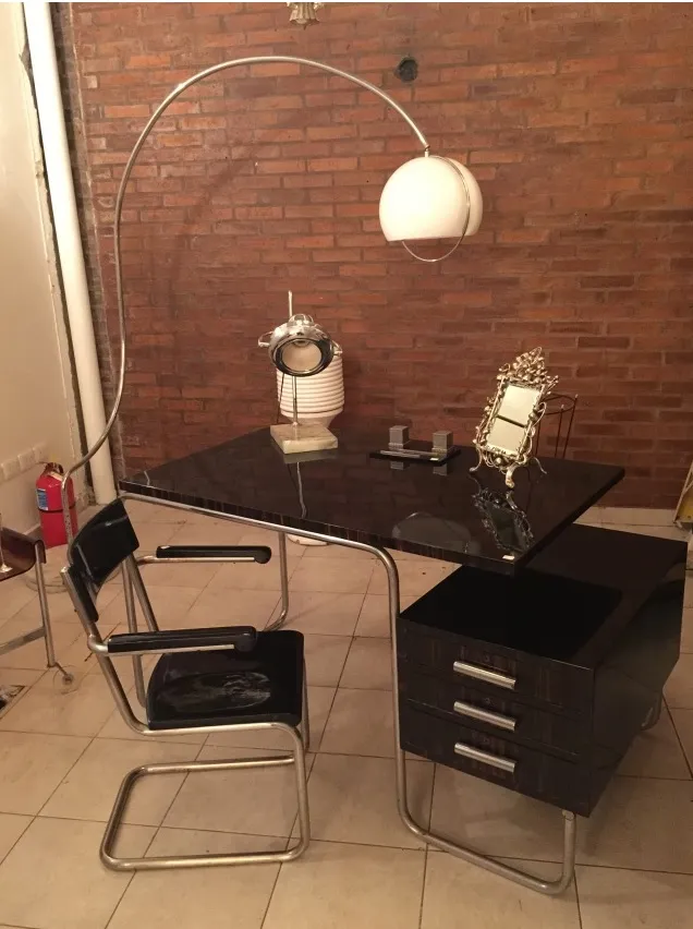 antique table lamp with a unique and elegant design, illuminating a modern desk with a warm glow