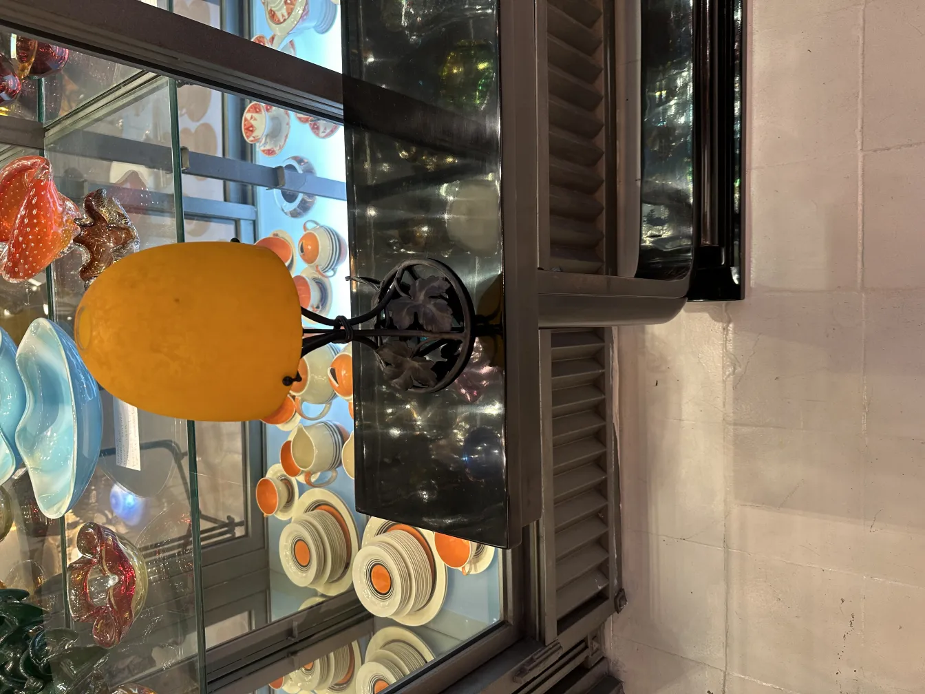 Antique table lamp with yellow shade in a display environment