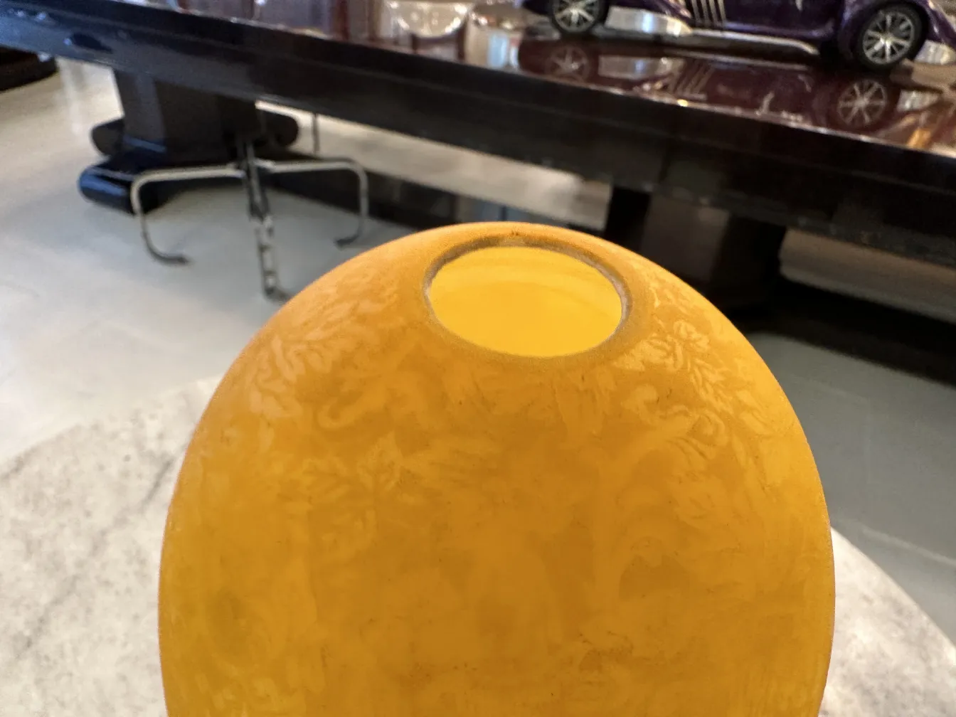 Top view of an antique yellow table lamp with floral details