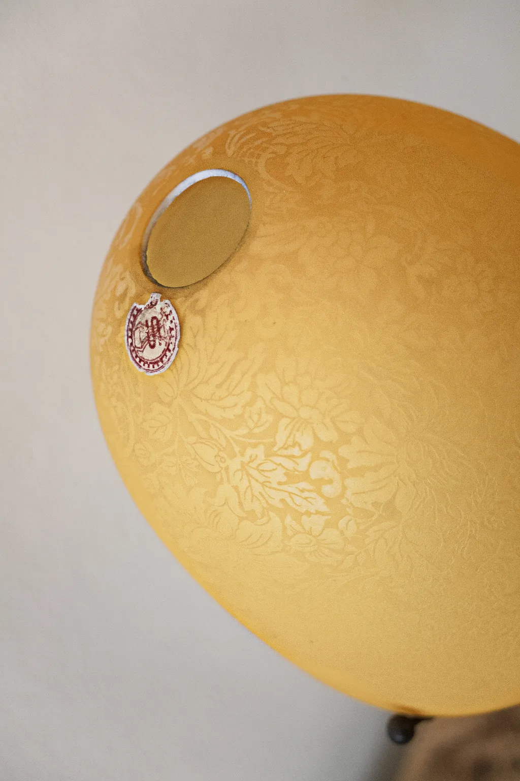 Antike Tischlampe in Gelb mit floralem Design, gemütliche Atmosphäre.