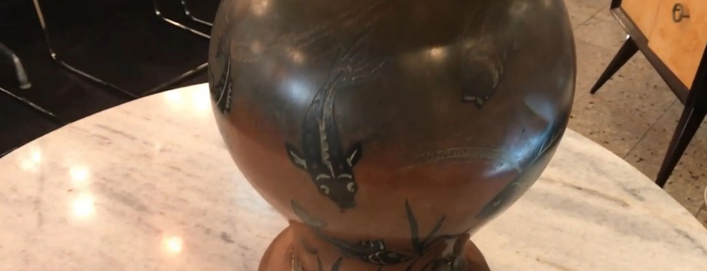 antique table lamp with round body and fish decoration