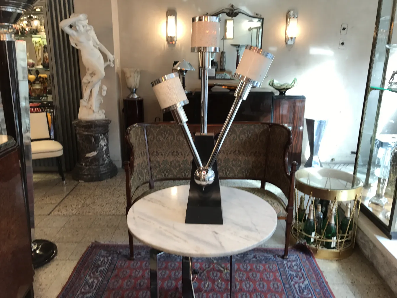 Antique table lamp with three arms and shades. Decorated background.