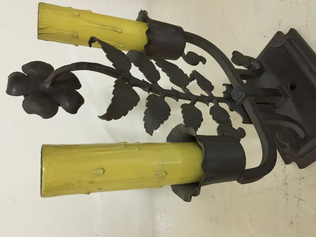 Antique table lamp with two yellow lights and floral metal design.