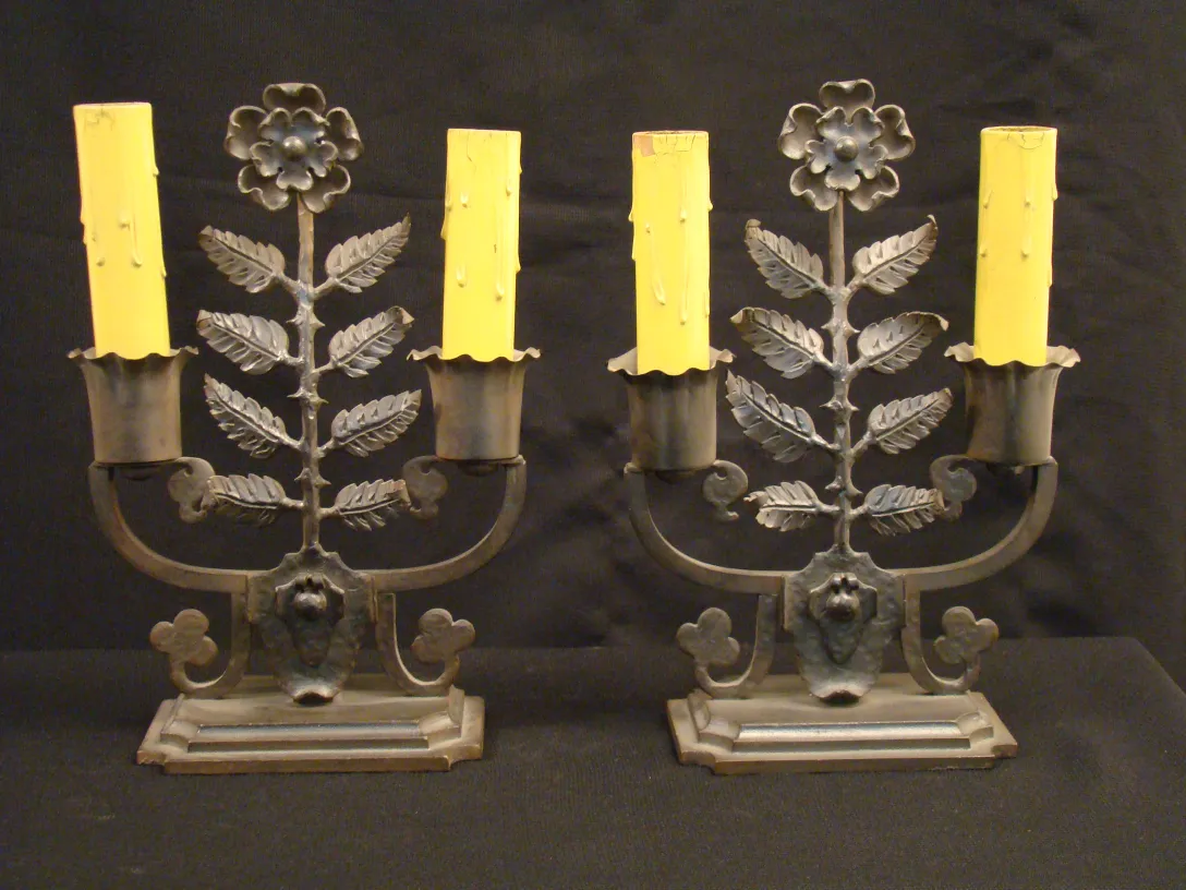 due lampade da tavolo antiche con candele gialle e foglie decorative