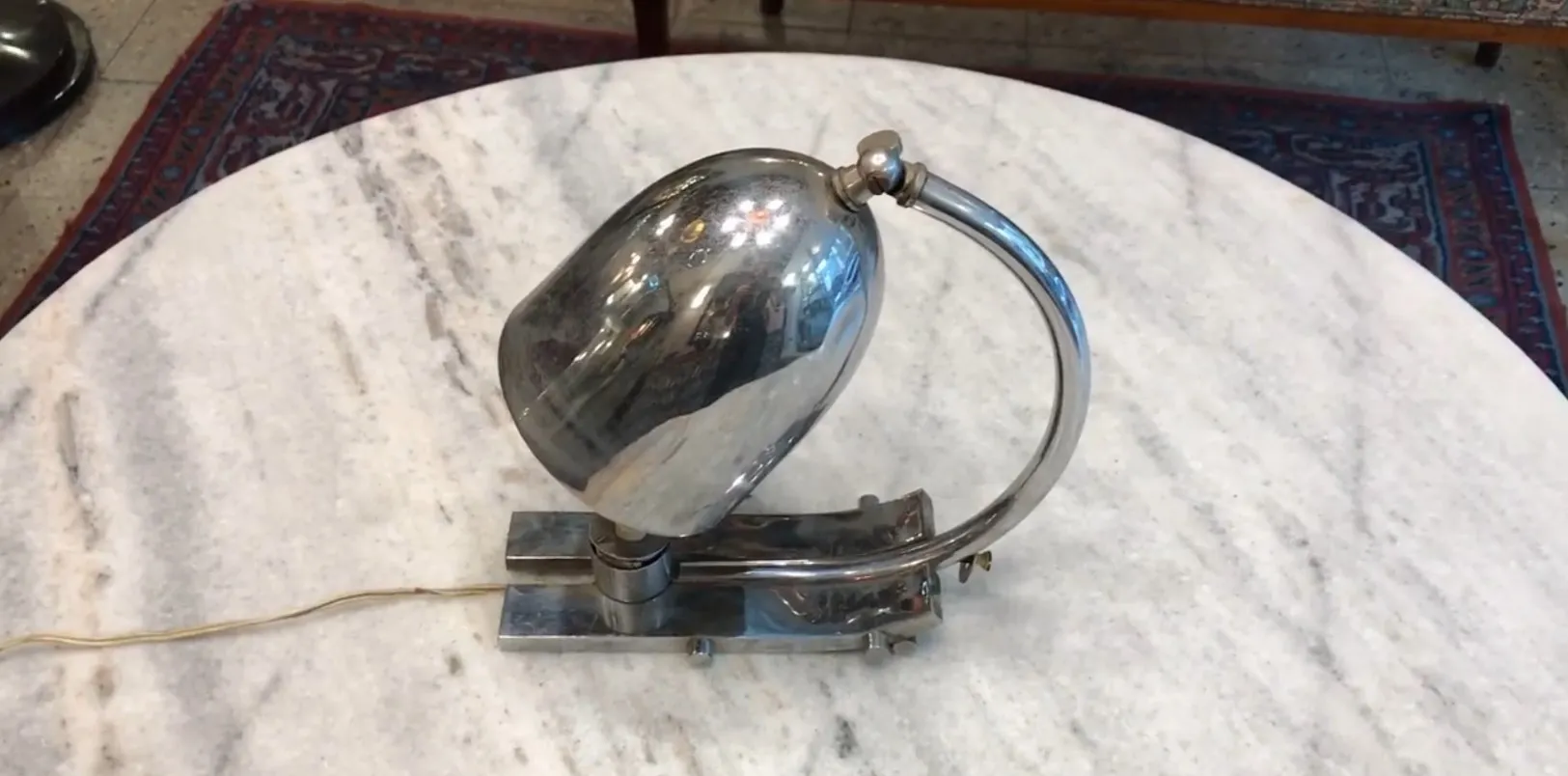 Antique shiny table lamp with a metallic base and elegant design, in a cozy setting.