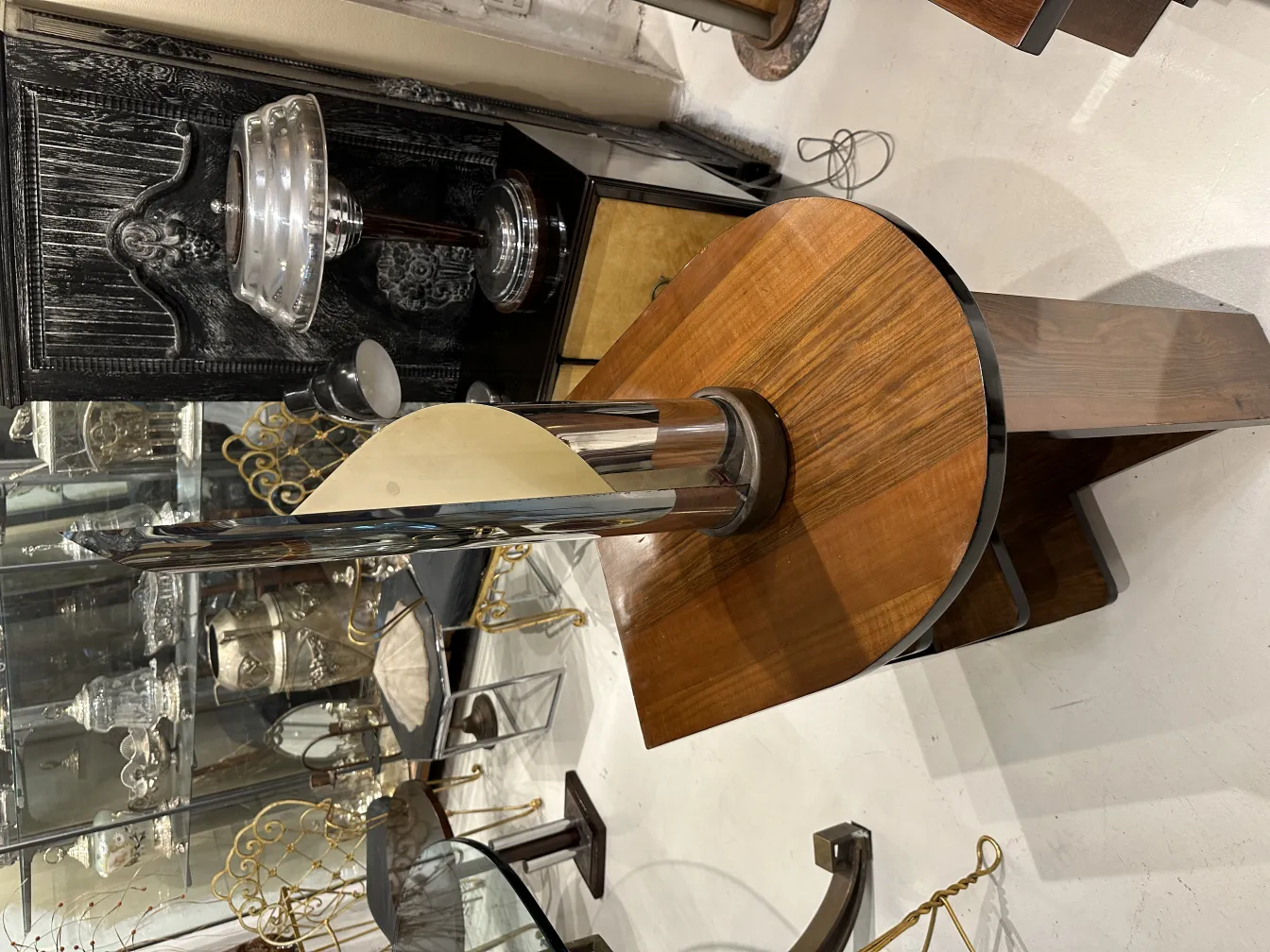 Antique table lamp with elegant base and distinctive design in a classic setting.