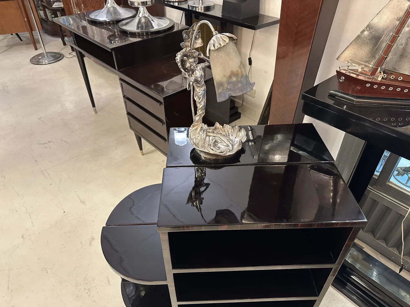 Antique table lamp with intricate design, placed in a cozy setting with vintage furniture.