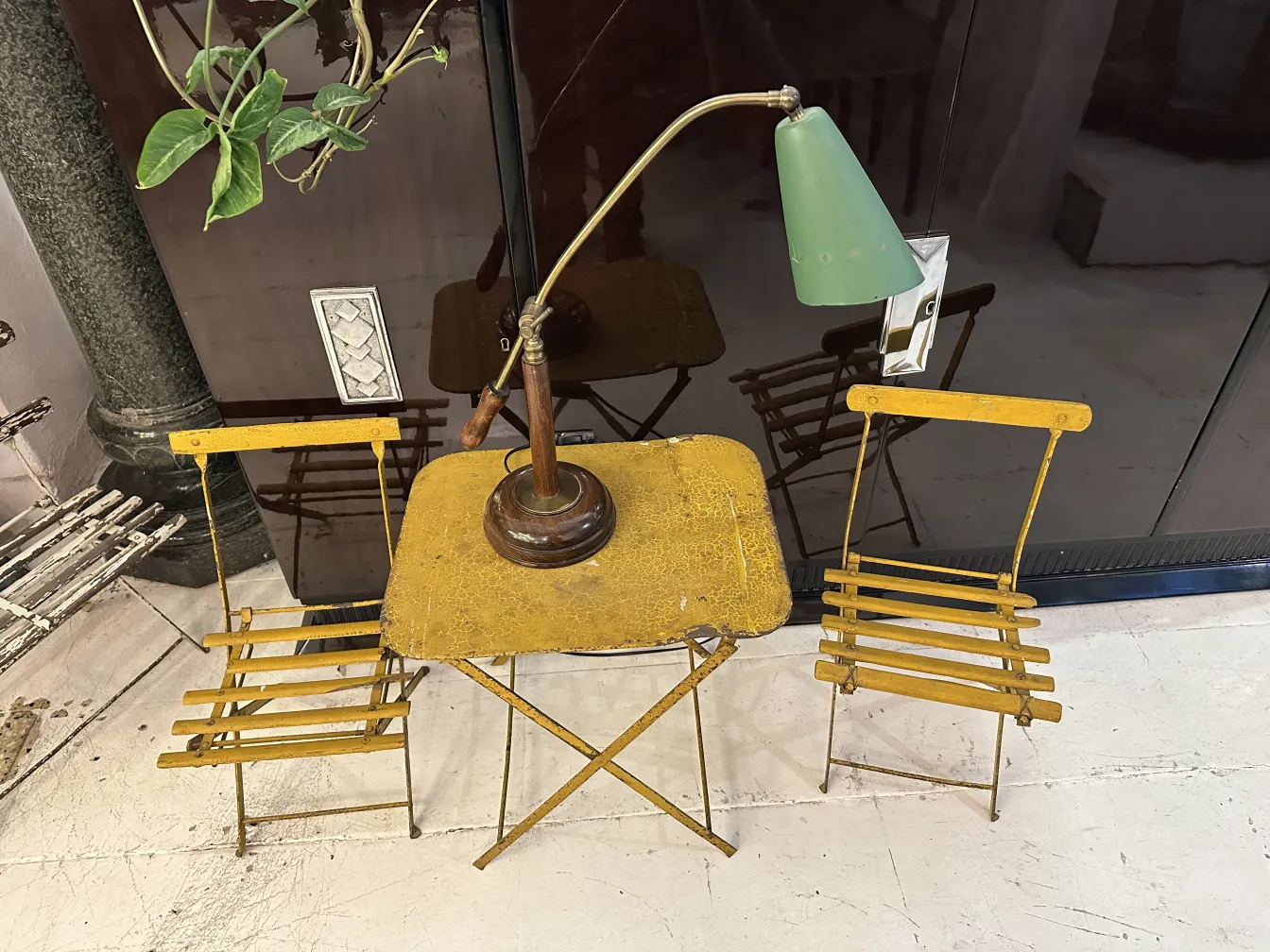 Lampe de bureau ancienne à côté de chaises jaunes dans le salon