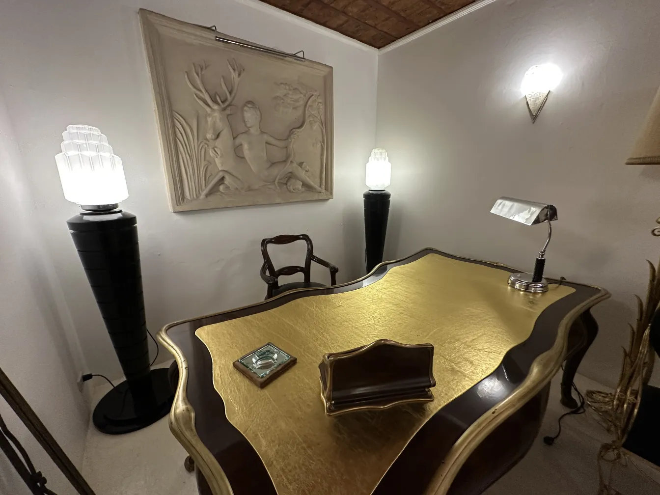 antique table lamp with warm light on golden desk