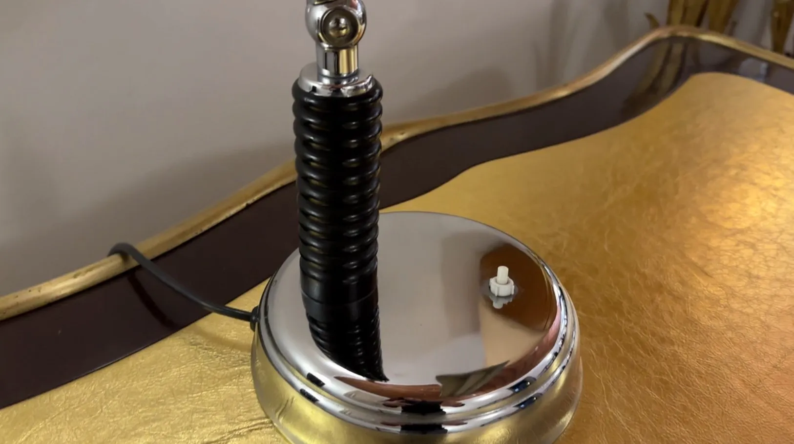 Antique table lamp with a shiny, elegant base, perfect for any room.