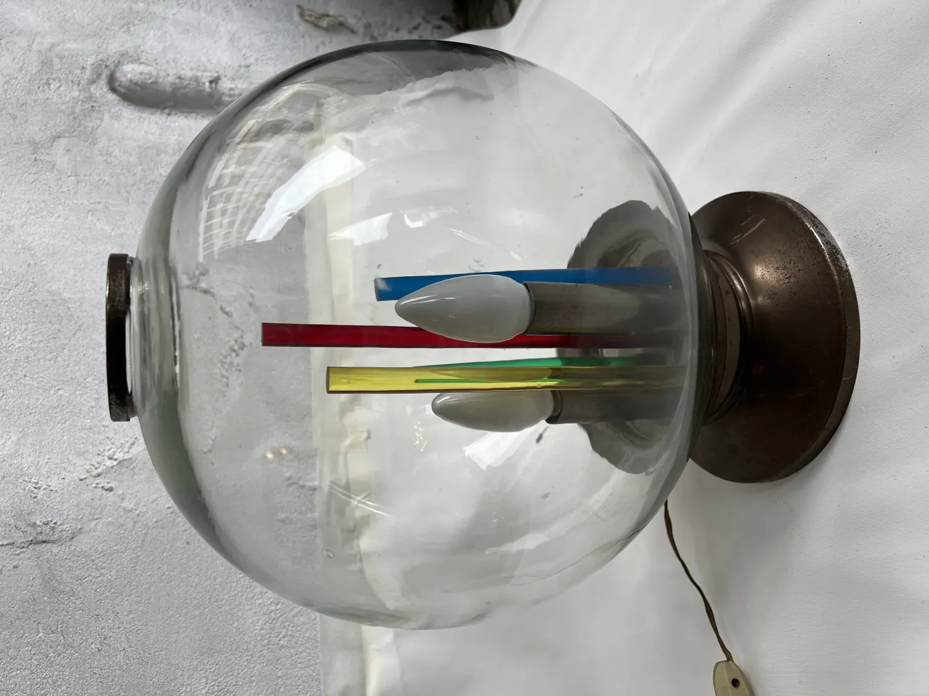 Antique table lamp with a clear glass dome and multicolored details inside