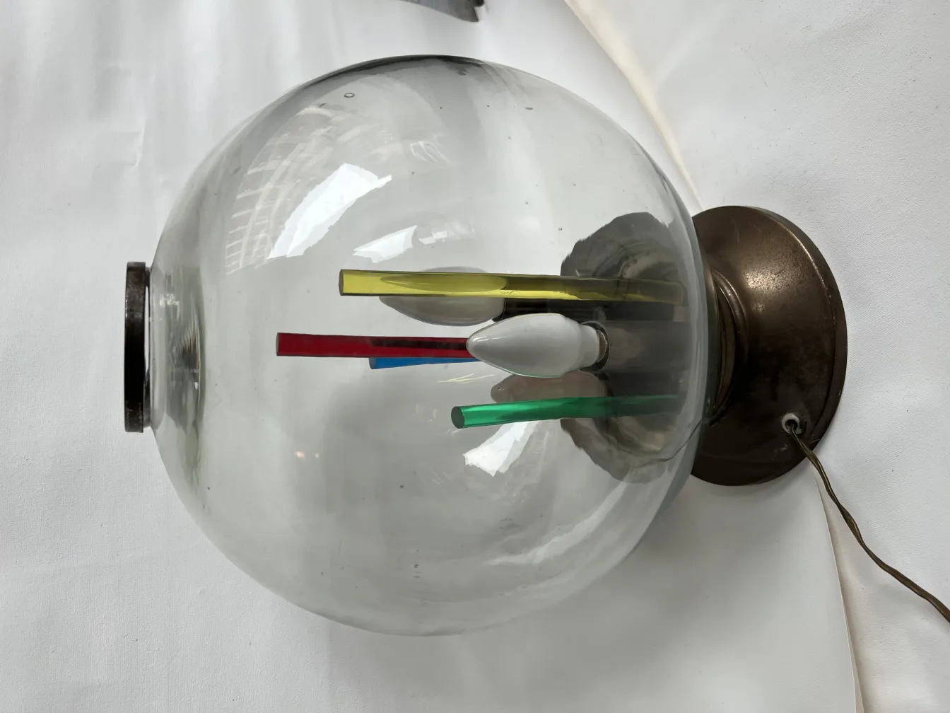 antique table lamp with clear glass globe and bright colored rods inside