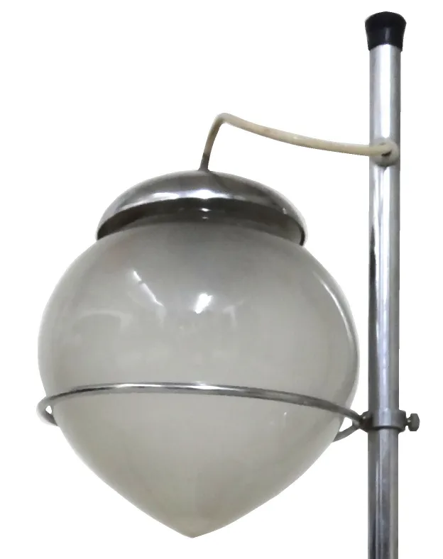 Antique table lamp with a spherical glass shade and metal base, set in a classic environment.
