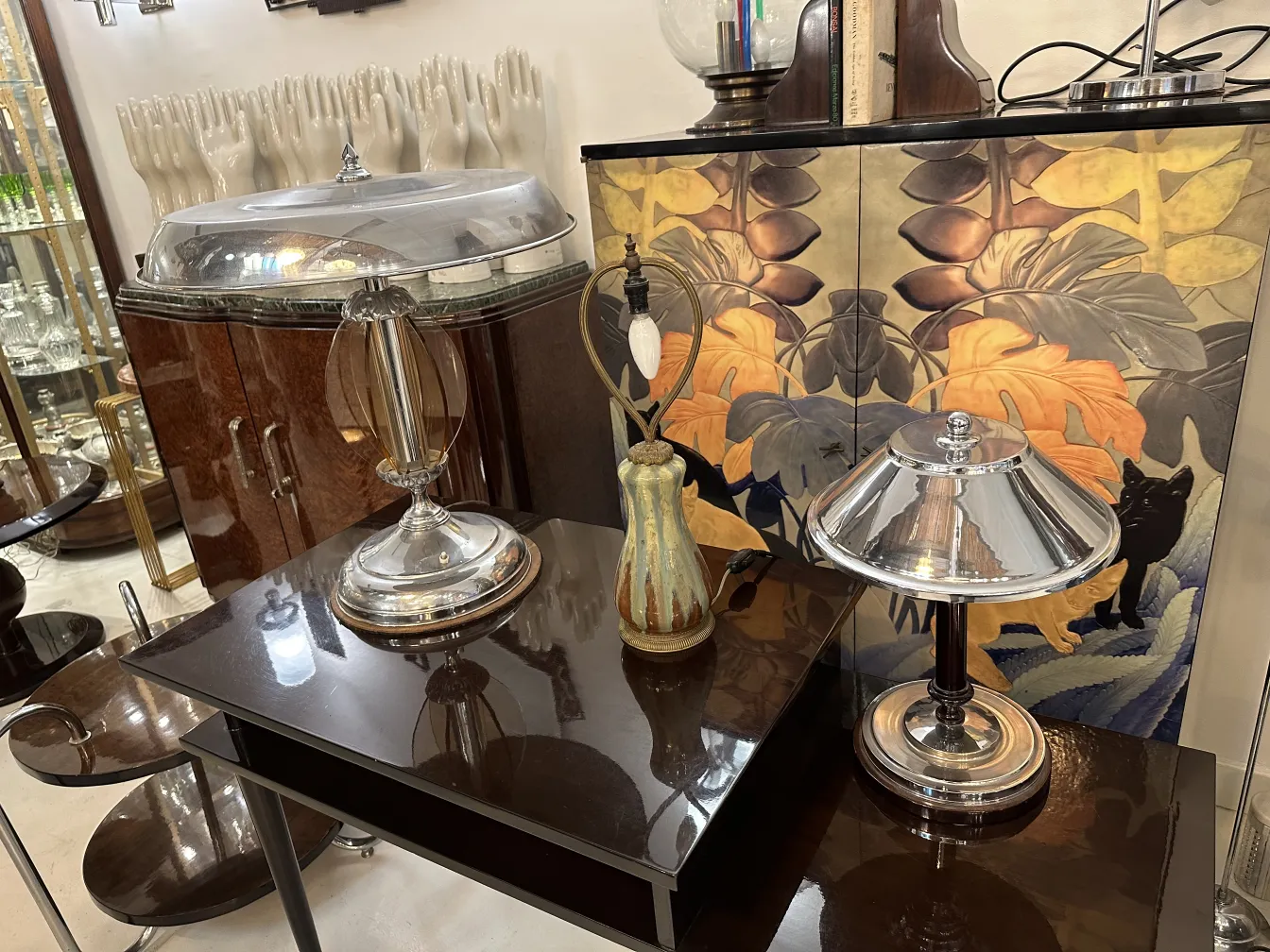 Antique table lamp with minimalist style featuring a shiny base and conical shade.