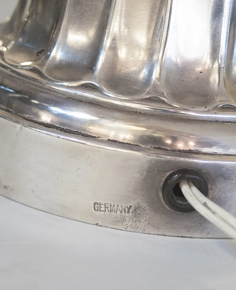 close-up of an antique table lamp charles schneider with silver base and visible cord