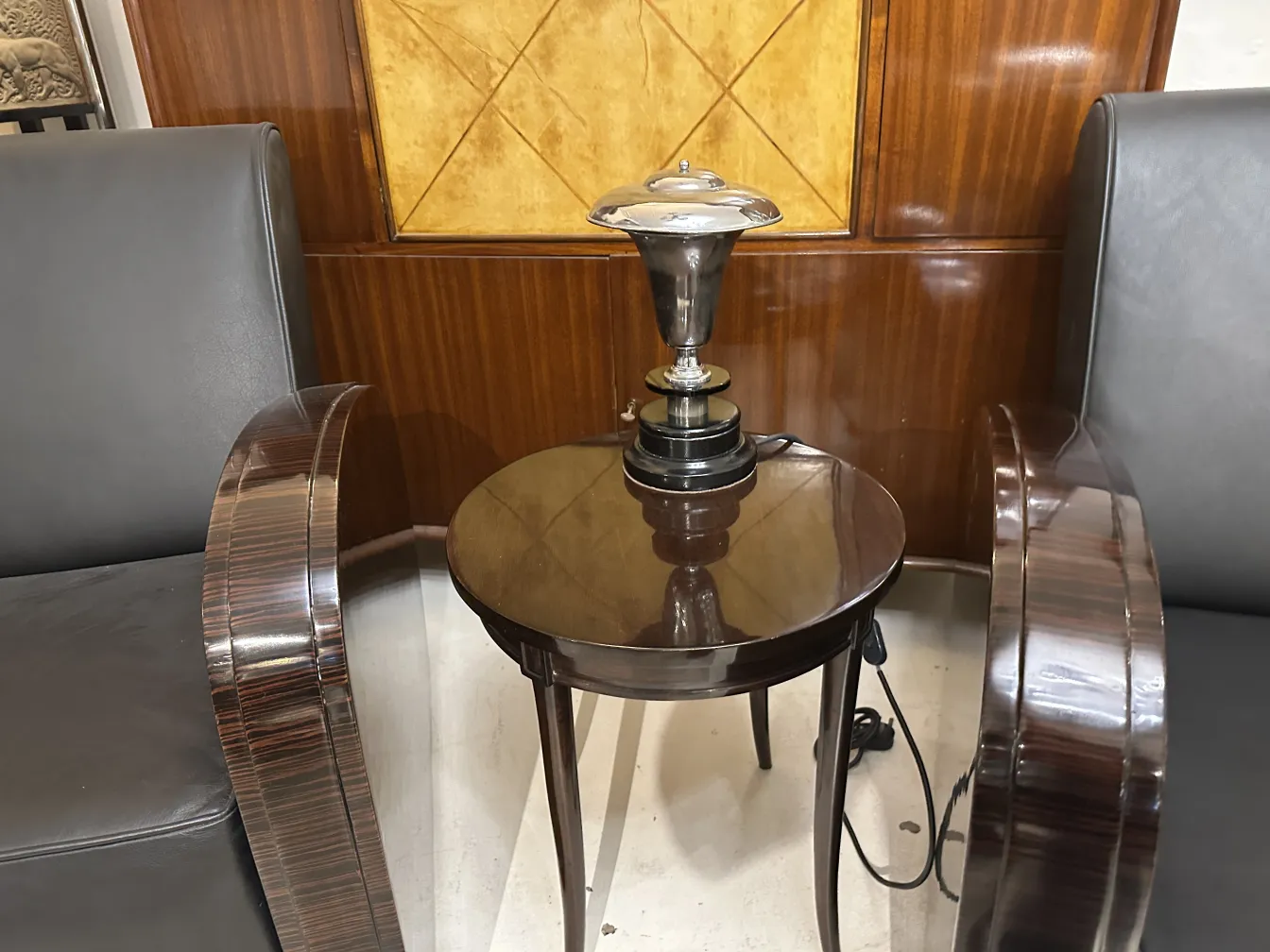 Antique table lamp with black base on a side table
