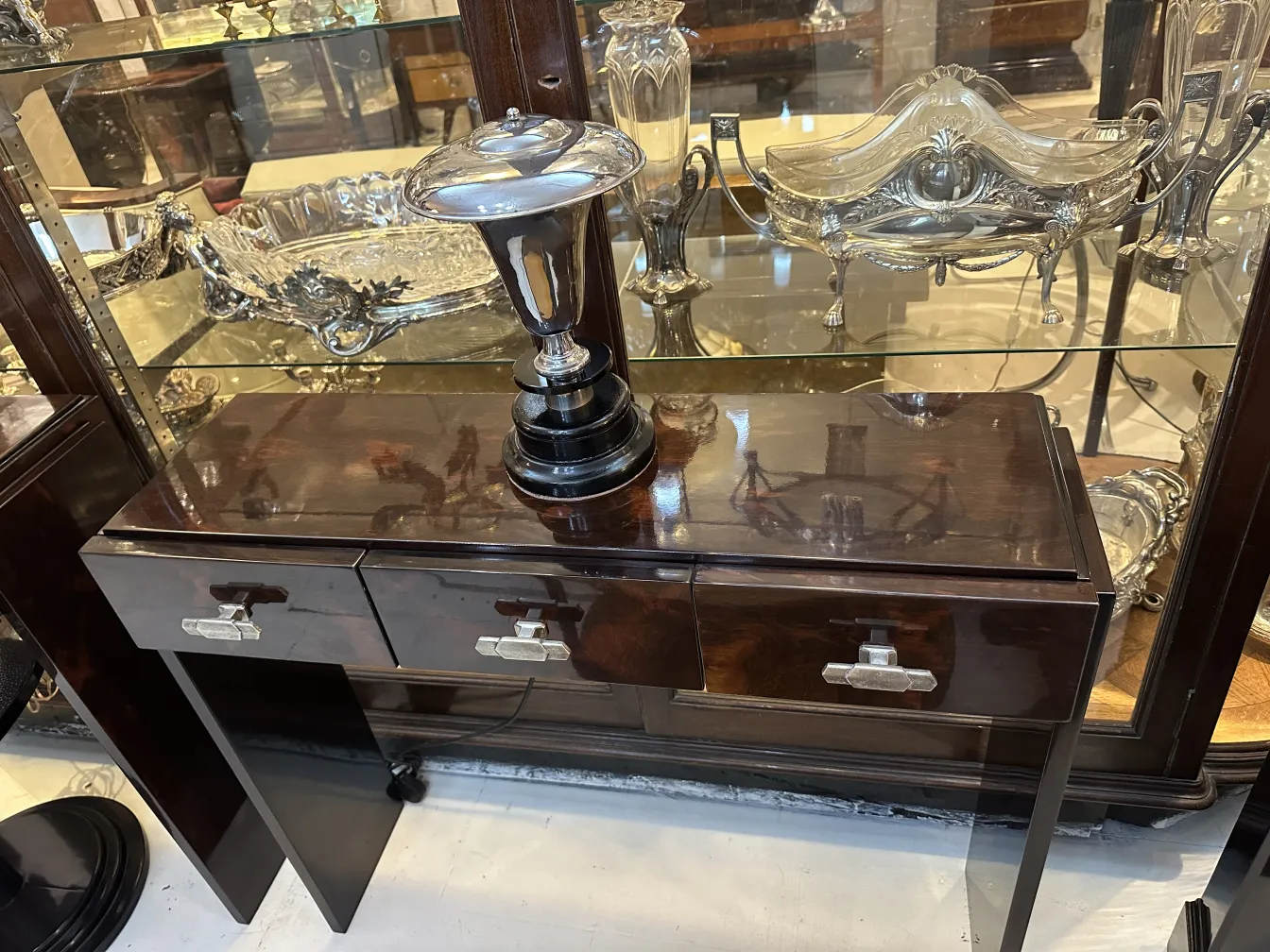 Antique table lamp shining, in a classic setting with decorative details.