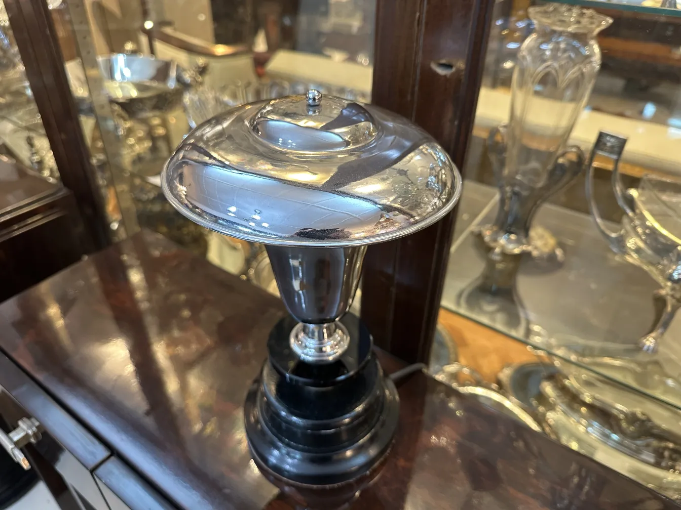 Antique shiny table lamp with black base, classic setting.