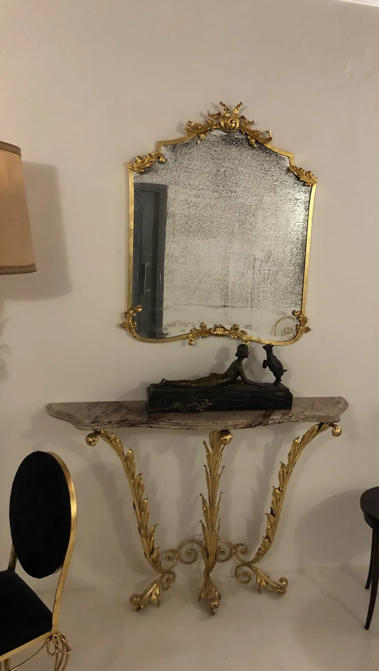 antique golden console with decorative mirror and figure