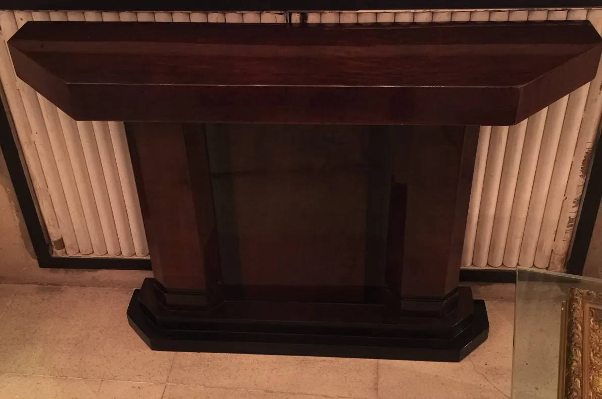 Antique console with rectangular shape and wide base.