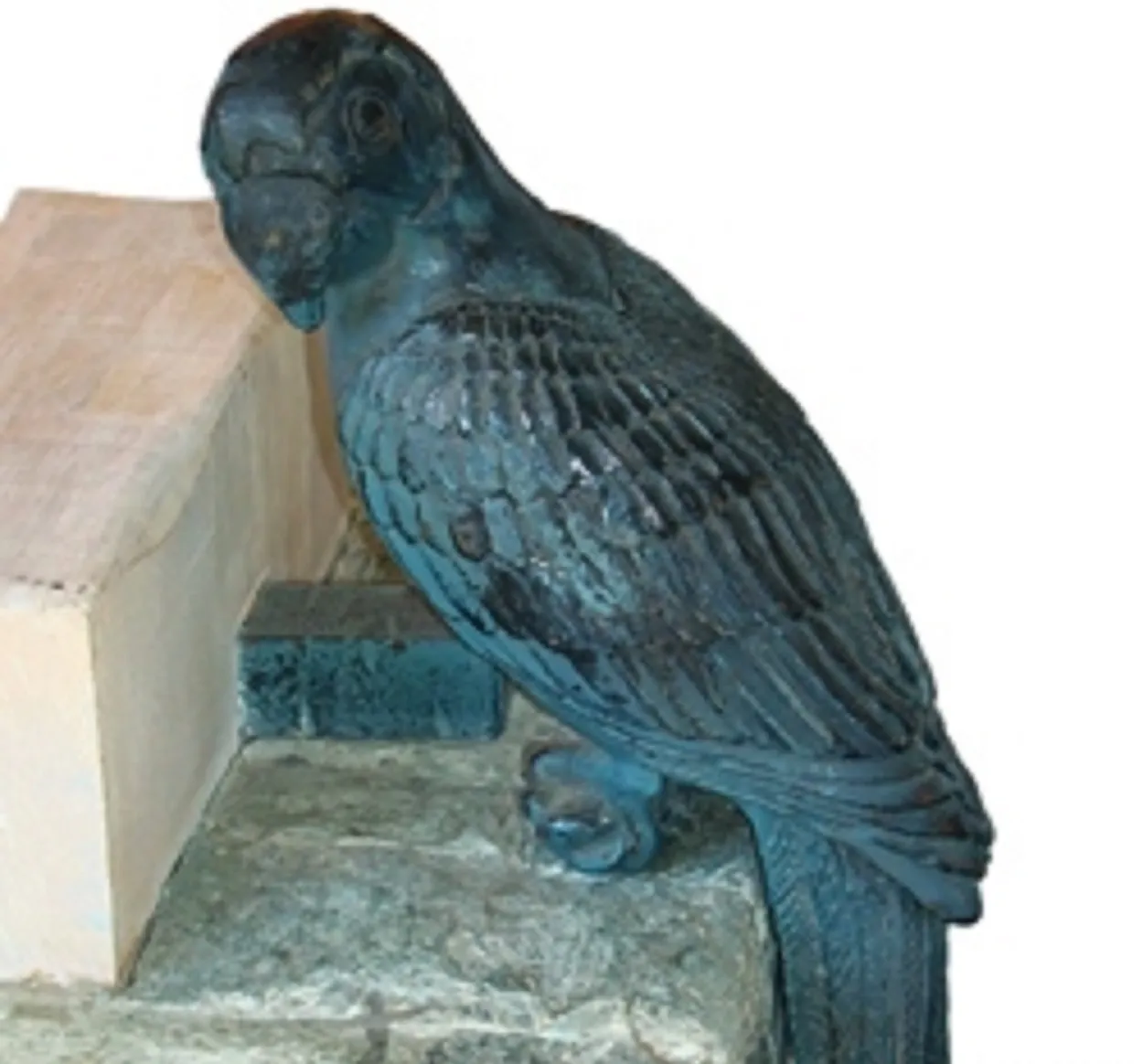 Consola ancienne avec un oiseau sur le dessus.