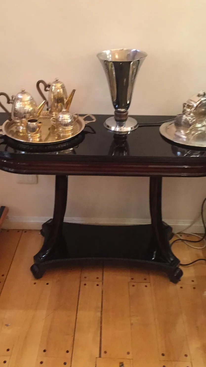 antique console with silver accessories on top