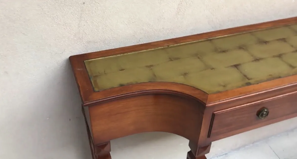 Antique console showcasing beautiful design with stylized details on top