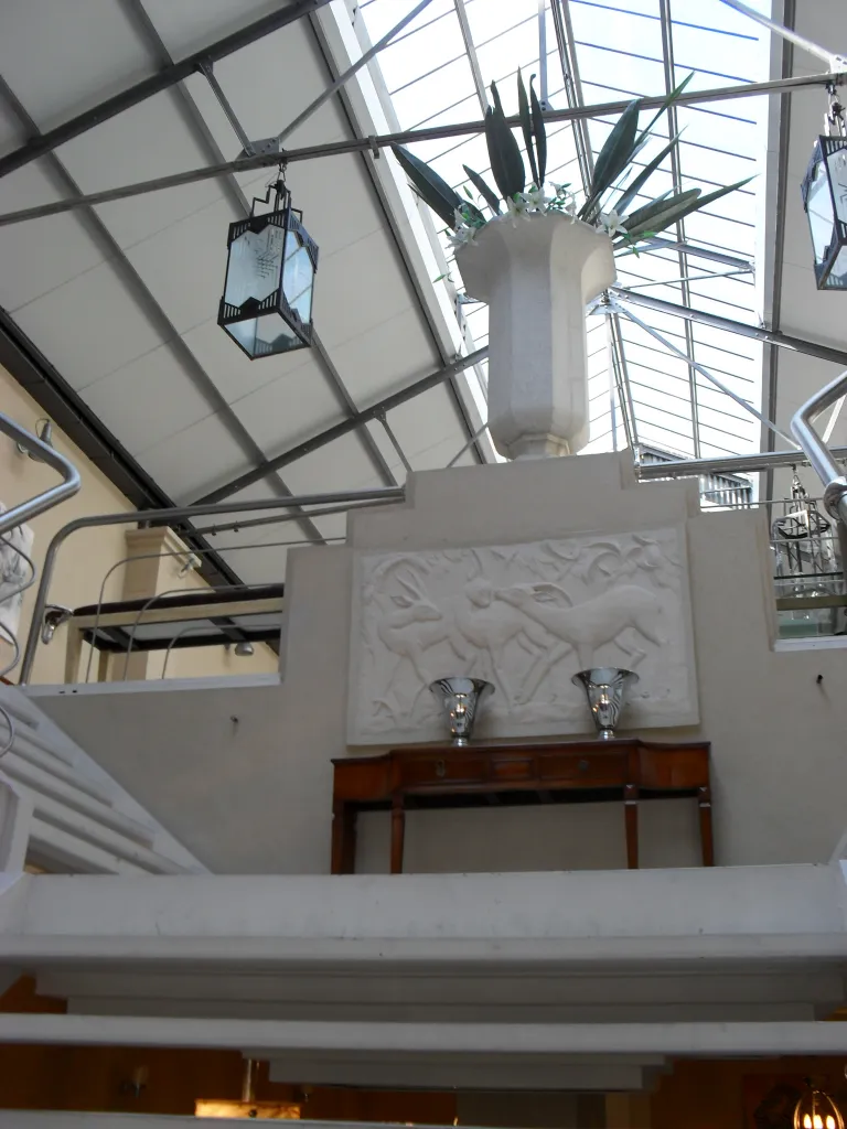 Ancient console in a bright space with natural light and greenery, decorated.